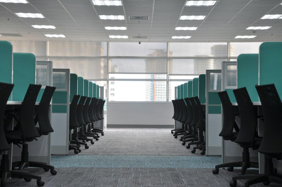 Rows of empty office chairs at clean, tidy workstations