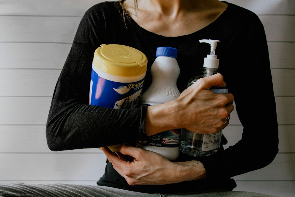 An armful of cleaning products and supplies