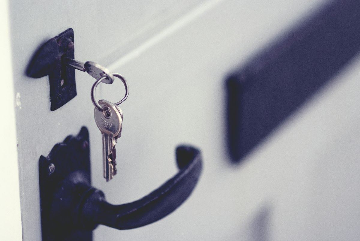 A key in the lock of a white door