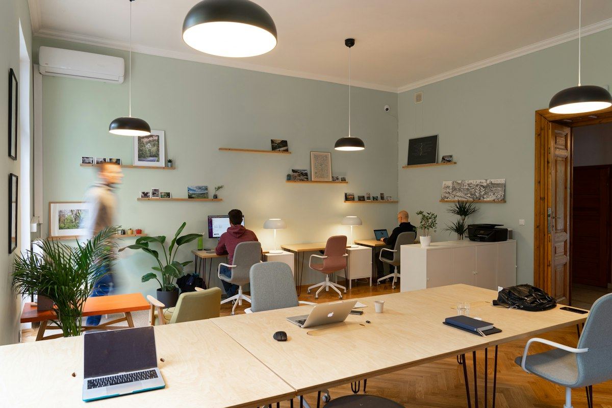 A modern shared workspace with desks and plants