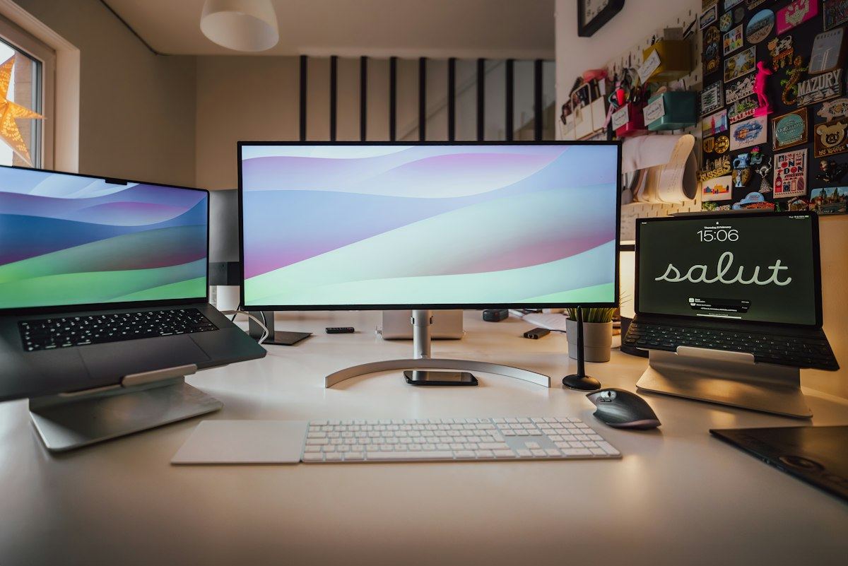 A desk with a computer and monitors