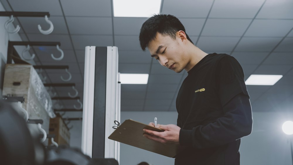 A cleaning supervisor with a clipboard inspecting a building