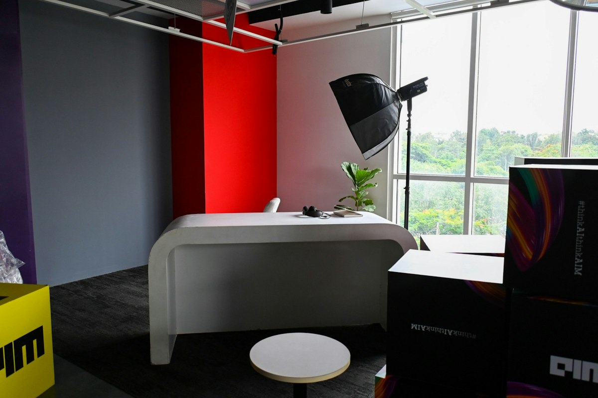 A creative studio desk with lighting equipment and a view of the city