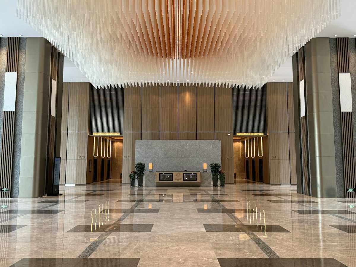A marble-floored office lobby with a decorative ceiling