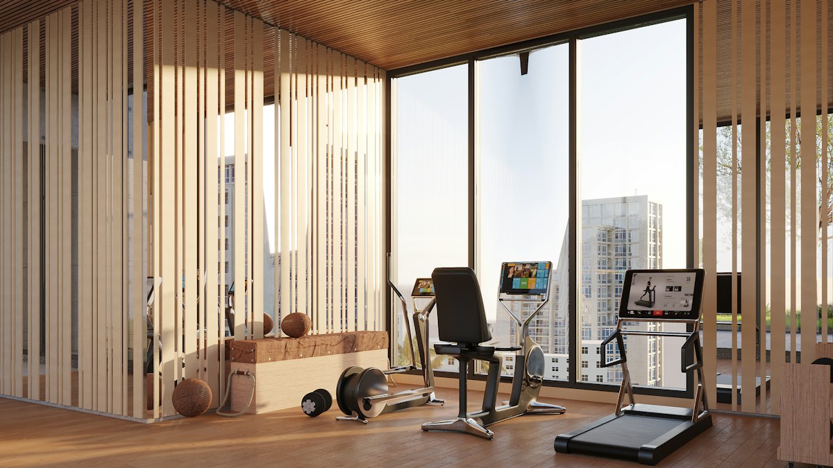 A modern gym with exercise equipment, wooden slats and city views