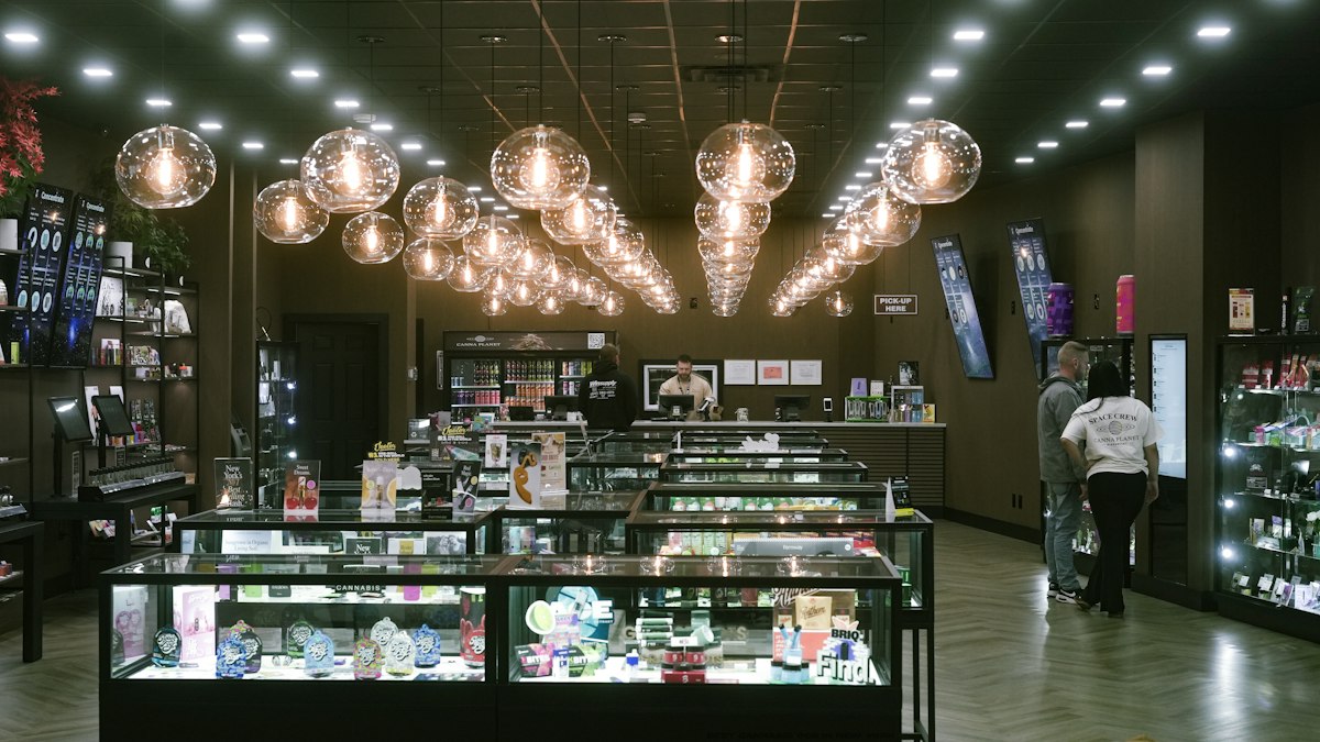 A modern retail store with glass display cases and warm lighting