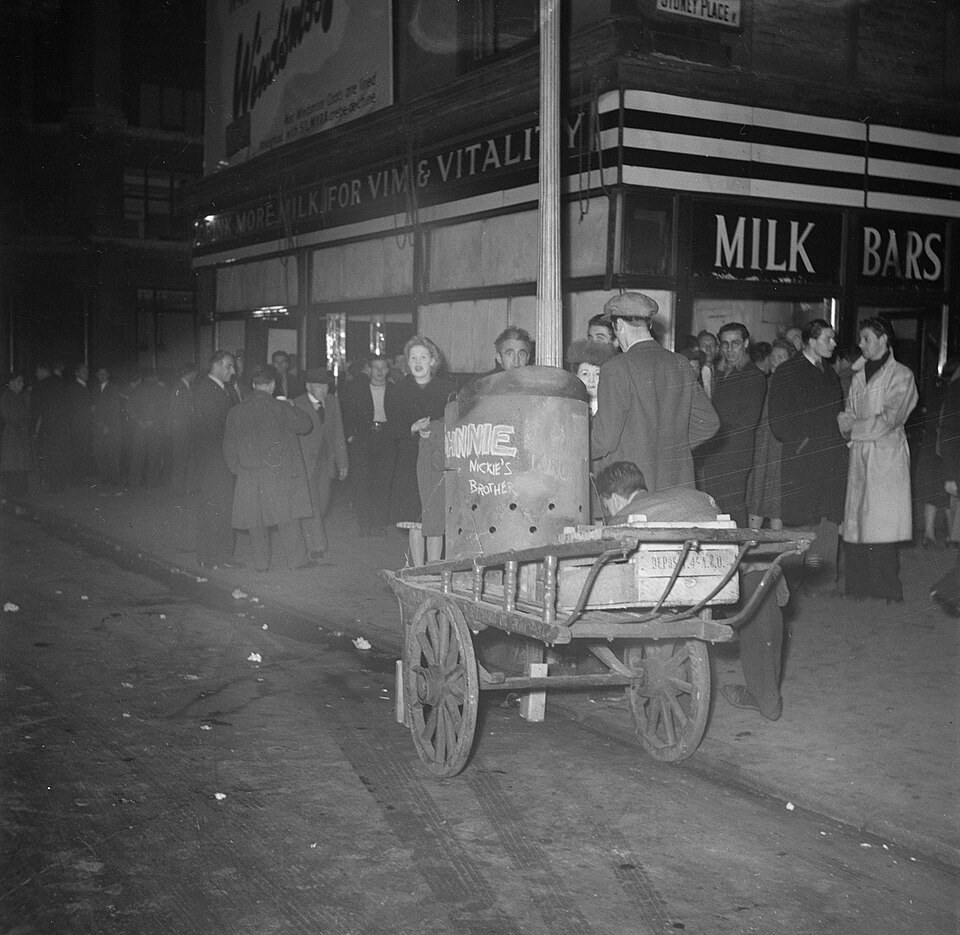 People gathered around a milk bar and a handcart in Leicester Square in 1947, in an archive photograph