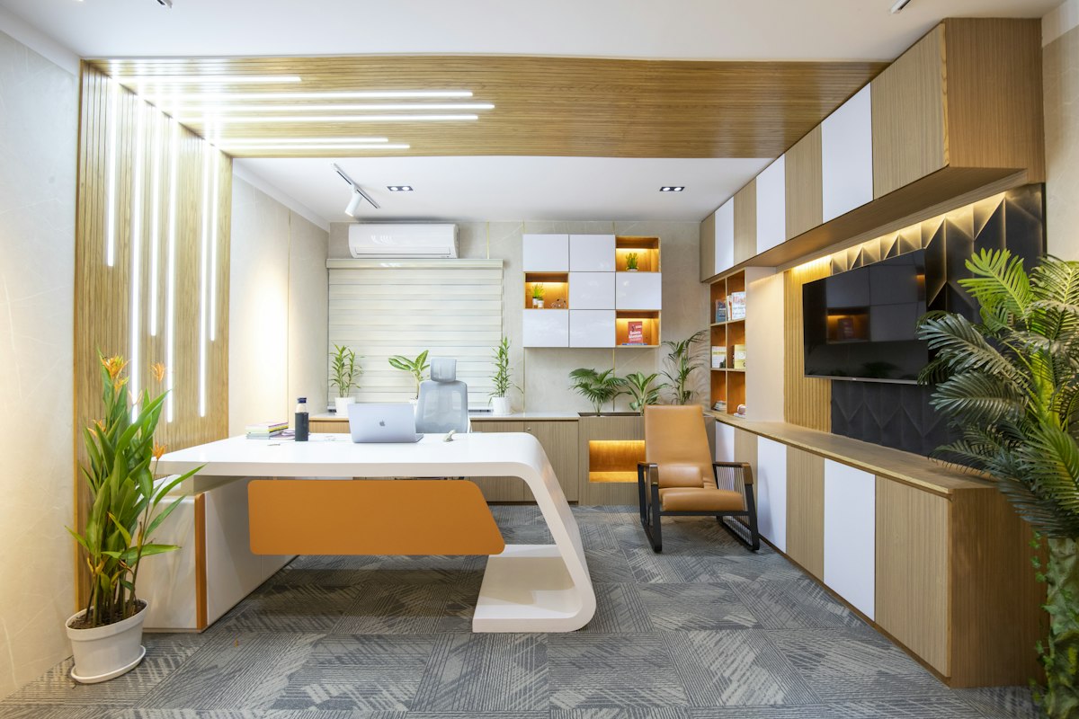 A bright, modern office with wood-panelled desks and plants, the kind of Shoreditch workplace we clean