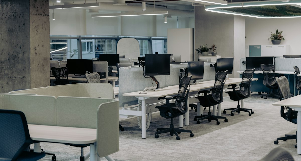 A modern open-plan office with height-adjustable desks, the kind of Vauxhall workplace we clean