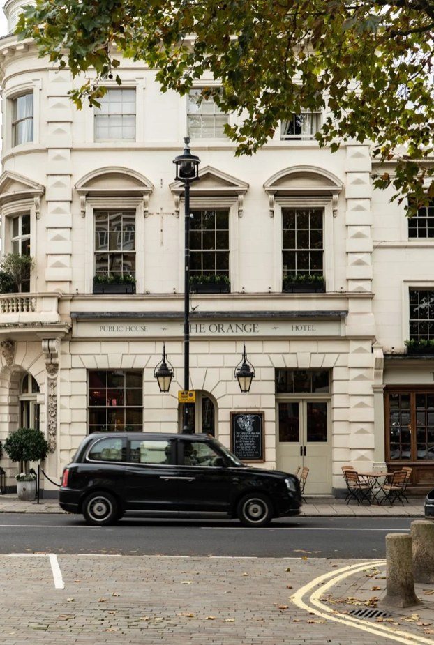 The Orange public house and hotel on a Pimlico square, with a black London taxi