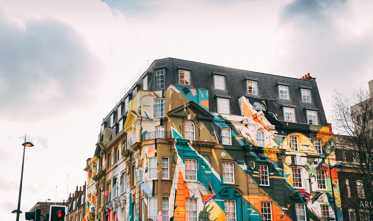 A mural-covered building on a Shoreditch street