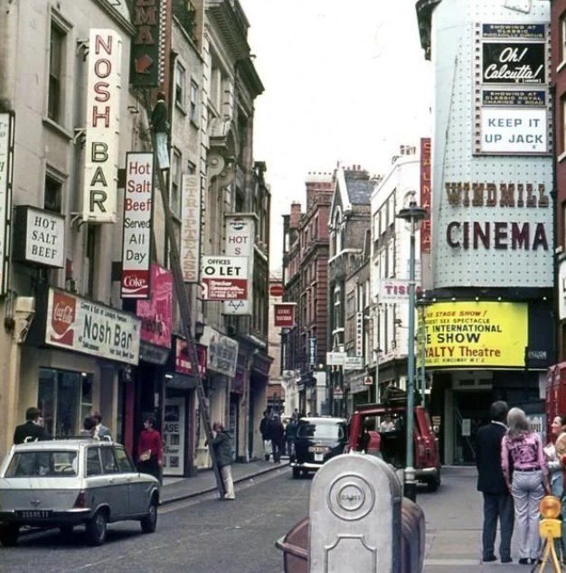 A Soho street in the 1970s, with the Windmill Cinema and neon shop signs