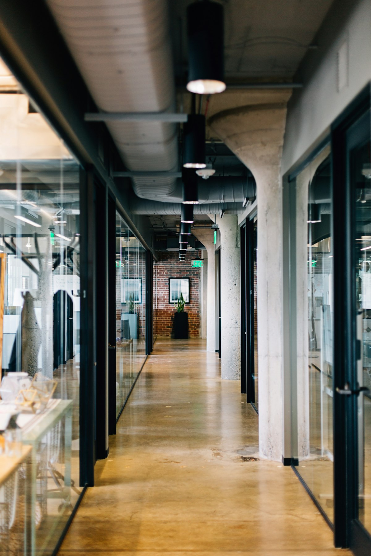 A long, clean office corridor with glass walls, ready for handover